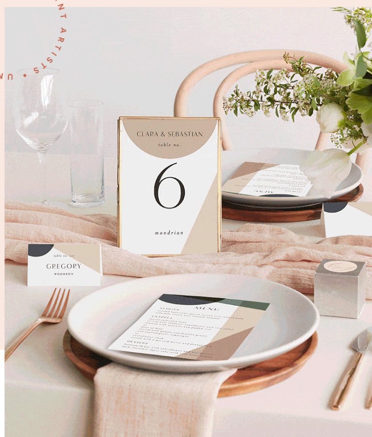 A beautifully set wedding table featuring a menu card and table number. The table is elegantly arranged with fine linens and place settings, with the menu card and table number adding a touch of refinement to the overall aesthetic.